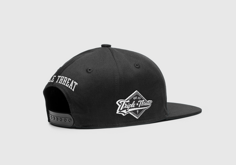 Side view of Triple Threat black snapback with 'Triple Threat' embroidered on the back and the diamond logo on the side 