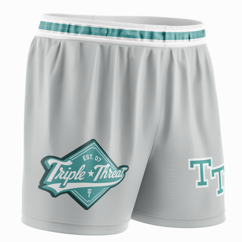 Grey basketball shorts with calligraphy "Triple Threat" around the waist inside teal strip, a teal and white diamond Triple Threat logo and "TT" 