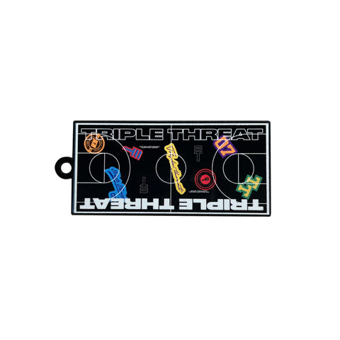 Metal Triple Threar key ring with a design of a black basketball court from birds eye view and various colorful Triple Threat logos