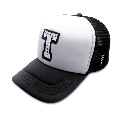 Triple Threat Block Trucker Hat in black with a breathable mesh back, adjustable snapback closure, structured front panels, and high-quality embroidered logo