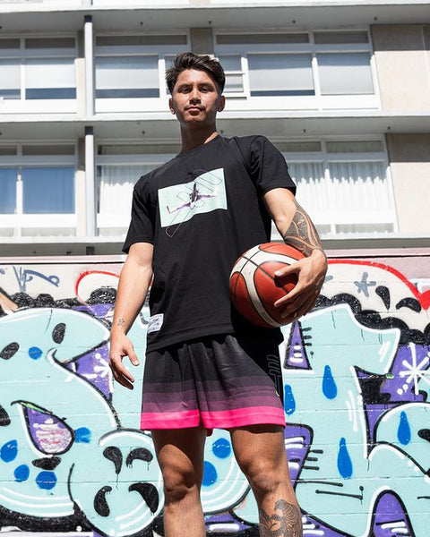 Model wearing Triple Threat basketball clothing holding a basketball in Wellington New Zealand