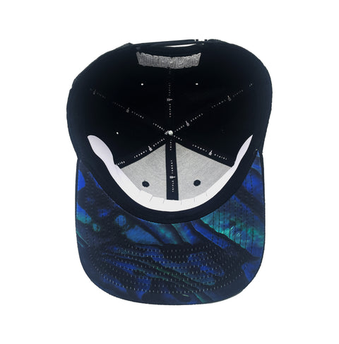 Underside of the black Triple Threat snapback with a paua design on the underside of the brim 